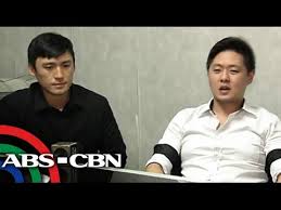 Bill Tan-Ang, (Left) surrenders after his cousin Karlvin Ang  (right) was mistakenly tagged as the gun toting motorist.